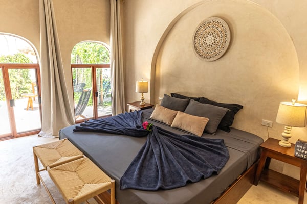 Warm bedroom with arched headboard at Villa Cayetana